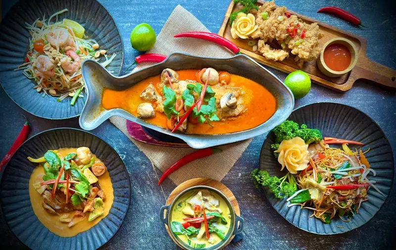 A Thai feast from above – whole fish in red curry, noodles, salads and soups